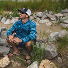 Load image into Gallery viewer, Action Shot on Rocks - Hydrotech Long Sleeve Performance Fishing Shirt - Deep Blue Camo - UPF 50+ Sun Protection - Men&#39;s Moisture Wicking Quick Dry T Shirt - Sportsman Gear
